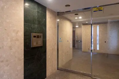 a hallway with a glass door in a building at Daffitto\u5929\u738b\u6d32 in Tokyo