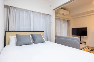 a hotel room with a bed and a television at \u30eb\u30af\u30ec\u521d\u53f0 in Tokyo