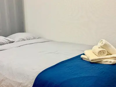 a bed with towels sitting on top of it at Ikebukuro Sugamo\u99c5\u8fd1\u6700\u592710\u4eba\u53ef in Tokyo