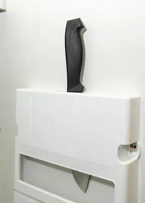a white cabinet with a knife on top of it at OHAYO AN asakusa in Tokyo