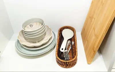 a basket filled with plates and dishes next to a knife at OHAYO AN asakusa in Tokyo