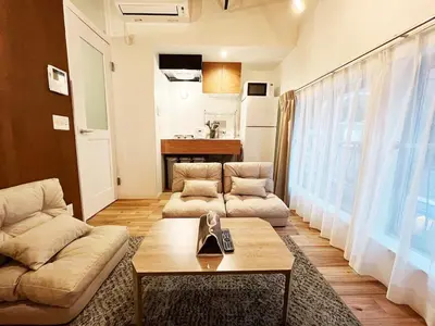 a living room with a couch and a coffee table at SSr\u5927\u548c\u753a1\u4e01\u76ee in Tokyo