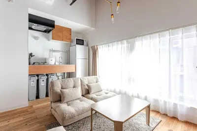 a living room with a couch and a table at SSr\u5927\u548c\u753a1\u4e01\u76ee in Tokyo