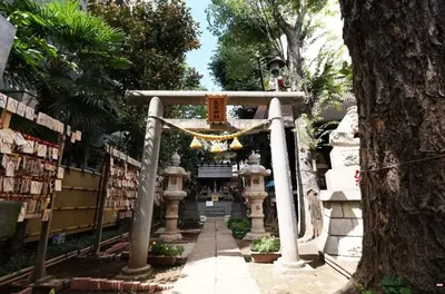 a shrine with a cross in front of a tree at SSr\u5927\u548c\u753a1\u4e01\u76ee in Tokyo