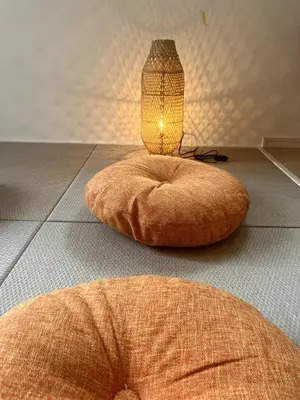 a lamp sitting on the floor next to a table at \u5927\u5cf65\u4e01\u76ee in Tokyo