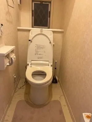 a bathroom with a toilet with the lid up at \u5927\u5cf65\u4e01\u76ee in Tokyo