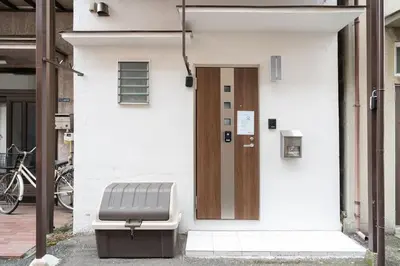 a door to a building with a bench in front of it at \u4eac\u5cf63\u4e01\u76ee\u8cb8\u6238\u5efa in Tokyo