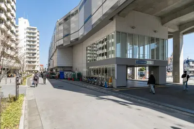 a large building with people walking in front of it at \u4eac\u5cf63\u4e01\u76ee\u8cb8\u6238\u5efa in Tokyo