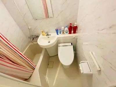 a small bathroom with a toilet and a sink at Okubo House 3F SJ0277 in Tokyo