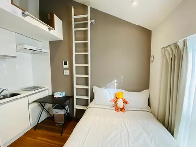 a small bedroom with a bed with a teddy bear on it at Okubo House 3F SJ0277 in Tokyo