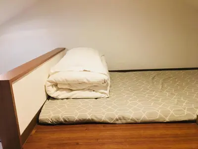 a bed with two pillows on it in a room at Okubo House 3F SJ0277 in Tokyo