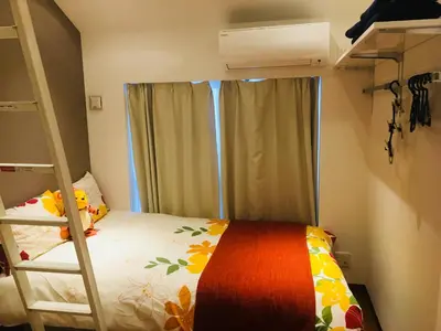 a small bedroom with a bunk bed and a window at Okubo House 3F SJ0277 in Tokyo