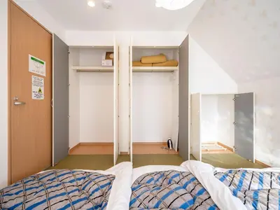 a bedroom with a bed and a closet at FAMILIA OMORIKAIGAN - Vacation STAY 18448 in Tokyo