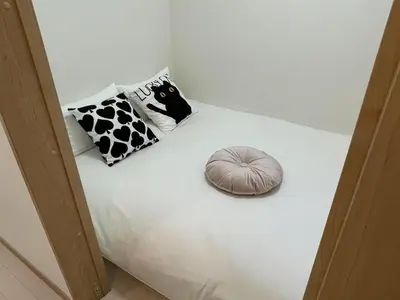a bed with two pillows and a pumpkin on it at COMMA HOUSE Kitaikebukuro 203 in Tokyo