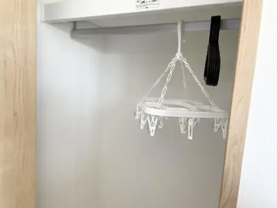a white curtain hanging from a shelf in a room at COMMA HOUSE Kitaikebukuro 301 in Tokyo