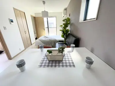 a room with a table with a potted plant on it at COMMA HOUSE Kitaikebukuro 301 in Tokyo