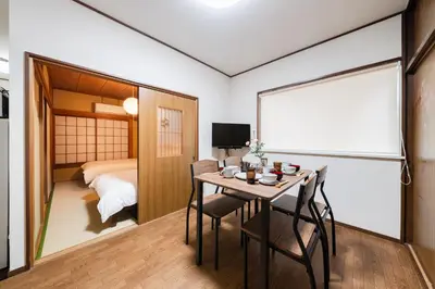 a room with a table and chairs and a bed at 4-chome House Senju 1F - Cozy Japanese-Style Apartment, 8 min to Kita-Senju in Tokyo