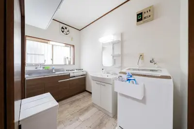 a white bathroom with a sink and a counter at 4-chome House Senju 2F - Cozy Japanese-Style Apartment, 8 min to Kita-Senju in Tokyo