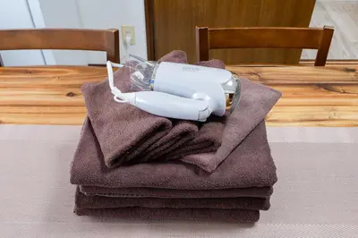 a white blender sitting on top of a pile of towels at 4-chome House Senju 2F - Cozy Japanese-Style Apartment, 8 min to Kita-Senju in Tokyo