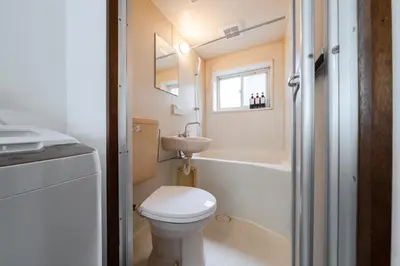 a small bathroom with a toilet and a sink at 4-chome House Senju 2F - Cozy Japanese-Style Apartment, 8 min to Kita-Senju in Tokyo