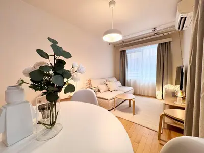 a living room with a vase of flowers on a table at P O IN T - Okachimachi Akihabara Designer's Home in Tokyo