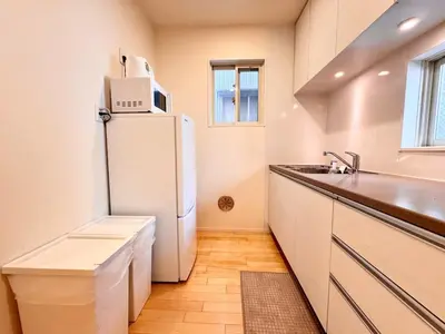 a kitchen with a white refrigerator and a sink at P O IN T - Okachimachi Akihabara Designer's Home in Tokyo