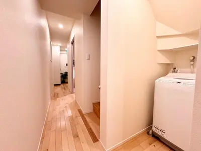 a laundry room with a washer and dryer and a hallway at P O IN T - Okachimachi Akihabara Designer's Home in Tokyo