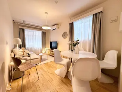 a white living room with a table and chairs at P O IN T - Okachimachi Akihabara Designer's Home in Tokyo