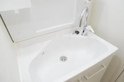 a white bathroom sink with a chrome faucet at Tsubaki in Tokyo