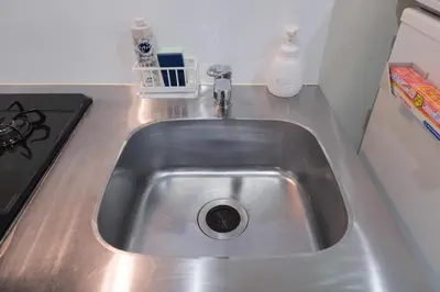 a stainless steel sink in a kitchen next to a stove at Tsubaki in Tokyo