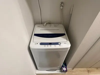a white stove in a corner of a room at Ikebukuro Area 2 Units NishiikeApartment in Tokyo