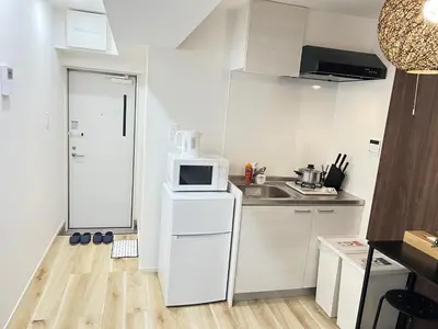a small kitchen with a sink and a microwave at Ikebukuro Area 2 Units NishiikeApartment in Tokyo