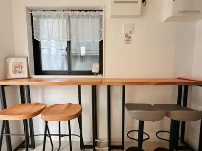 a bar with stools in front of a window at W-inns Asakusabashi in Tokyo