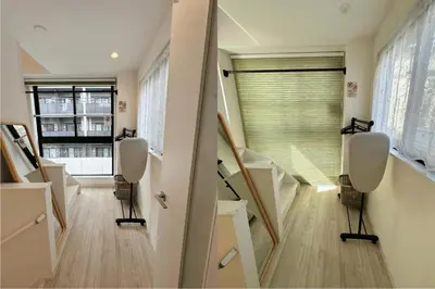 a room with stairs with chairs and a window at W-inns Asakusabashi in Tokyo