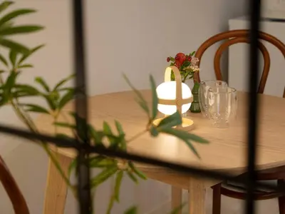 a wooden table with glasses and a candle on it at OPEN! TOKYO Kitasenju A Newly built stylish room! in Tokyo