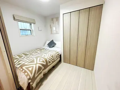 a bedroom with a bed and a large closet at OPEN! TOKYO Kitasenju A Newly built stylish room! in Tokyo