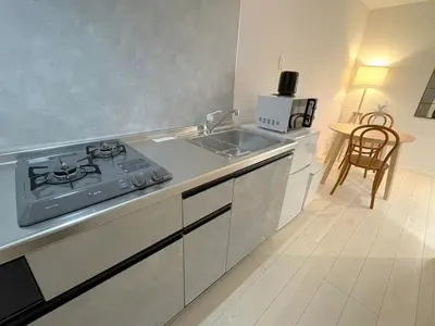 a kitchen with a stove and a sink at OPEN! TOKYO Kitasenju A Newly built stylish room! in Tokyo
