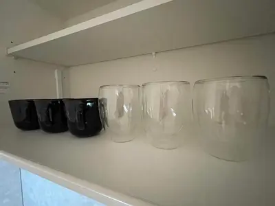 four empty wine glasses sitting on a counter at OPEN! TOKYO Kitasenju A Newly built stylish room! in Tokyo