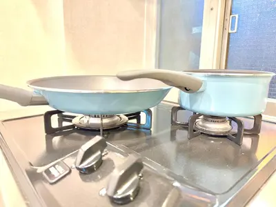 two pans sitting on top of a stove at \u6771\u65b0\u5bbf\u99c5\u65b0\u5bbf4\u4eba\u53ef b2 in Tokyo