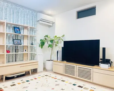 a living room with a flat screen tv on a entertainment center at Alo BnB 7 - Near IKEBUKURO, SHINJUKU, UENO - Self Check in - OYAMA Sta 3min in Tokyo