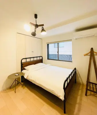 a bedroom with a bed and a ceiling fan at Alo BnB 7 - Near IKEBUKURO, SHINJUKU, UENO - Self Check in - OYAMA Sta 3min in Tokyo