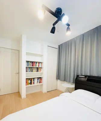 a bedroom with a bed and a ceiling fan at Alo BnB 7 - Near IKEBUKURO, SHINJUKU, UENO - Self Check in - OYAMA Sta 3min in Tokyo