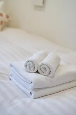 a stack of towels sitting on top of a bed at YXD101 Direct Skytree convenience facilities in Tokyo