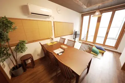 a conference room with a wooden table and chairs at Buddy Resort Kagurazaka in Tokyo
