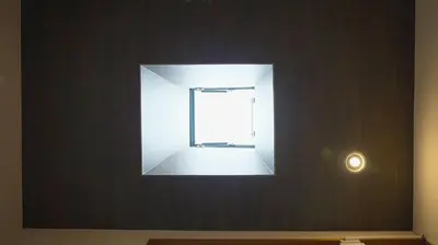 a window in a wall with a light on it at Buddy Resort Kagurazaka in Tokyo