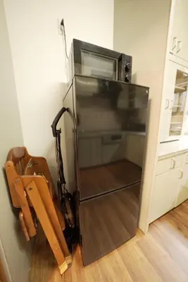 a refrigerator with a microwave in a kitchen at Buddy Resort Kagurazaka in Tokyo