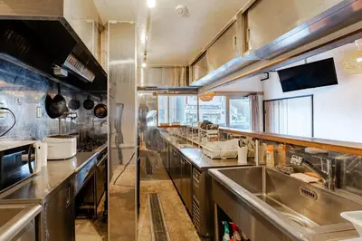 a large kitchen with stainless steel counters and sinks at Pro Kitchen and Karaoke 100sqm amusement hotel in Tokyo