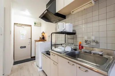 a kitchen with a stainless steel sink and a counter at Pro Kitchen and Karaoke 100sqm amusement hotel in Tokyo