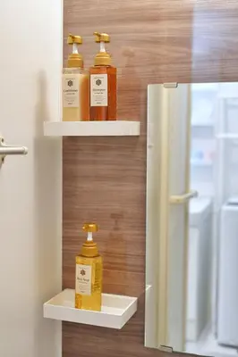 three bottles of honey on shelves next to a refrigerator at YXD301 Direct Skytree convenience facilities in Tokyo