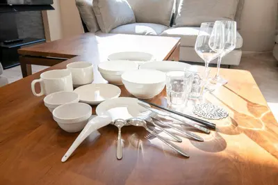 a table with white dishes and wine glasses on it at Ciel\u5357\u9ebb\u5e03 in Tokyo
